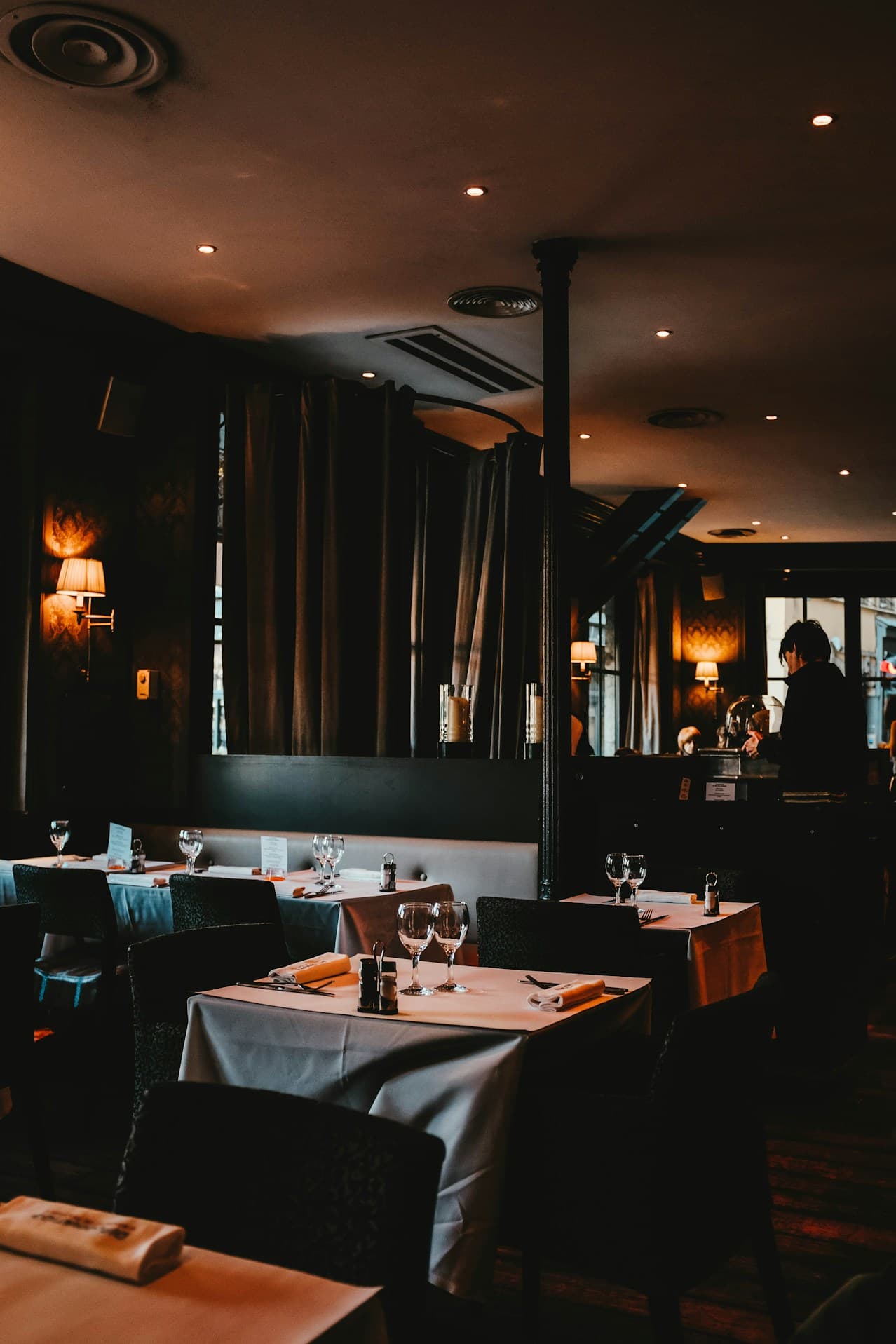 A restaurant dining room set for service
